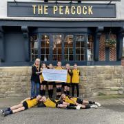 The Chester Nomads Zebras U11's team being presented with a cheque for £750 by Rachel Gerrard from the Peacock Hotel.