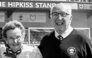 Barrie Hipkiss, pictured with wife Pam, in front of The Hipkiss Stand named after them at the Deva Stadium.