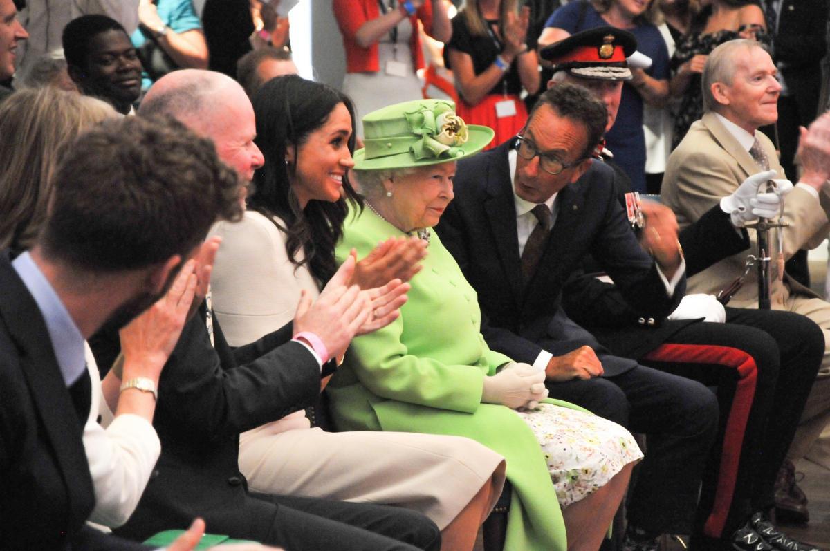 The Queen and Meghan, Duchess of Sussex, react with delight at the call for three cheers at Storyhouse, June 2018.