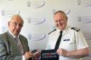 Police and Crime Commissioner for Cheshire John Dwyer and Chief Constable Mark Roberts with the seatbelt cover which will help thousands of neurodiverse children in Cheshire