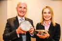Tyrer Charitable Trustee Clive Pointon and Brittany Green of Aaron and Partners, holding a pair of early 18th century silver footed salvers, purchased by the Trustees of the Tyrer Charitable Trust.