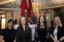 from left to right: Kate Harland, Museums and Heritage Manager, Brittany Lange and Chloe Jones from Sykes Holiday Cottages and Elizabeth Montgomery, Senior Curator, next to the model of the Roman Soldier at the Grosvenor Museum.