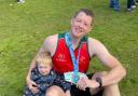 Scott Owen with his two-year-old son Arthur after finishing the Chester Marathon in support of Wales Air Ambulance charity