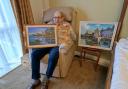 The care home's resident artist, Maurice, with some of his landscape pieces.