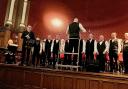Violinist Philip Chidell performs with Chester Male Voice Choir at Chester Town Hall.