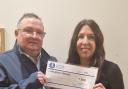 Adoption Matters Finance and Business Manager, Karen Davies, receives cheque off The Chester Bluecoat CEO Mike Jenkins.
