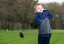 George Hughes, 7, playing golf at Wigan Golf Club at Arley Hall, Blockrod. A budding golfer is on course to raise £100,000 for charity by playing a round in five different countries in under 24 hours in memory of his late father.