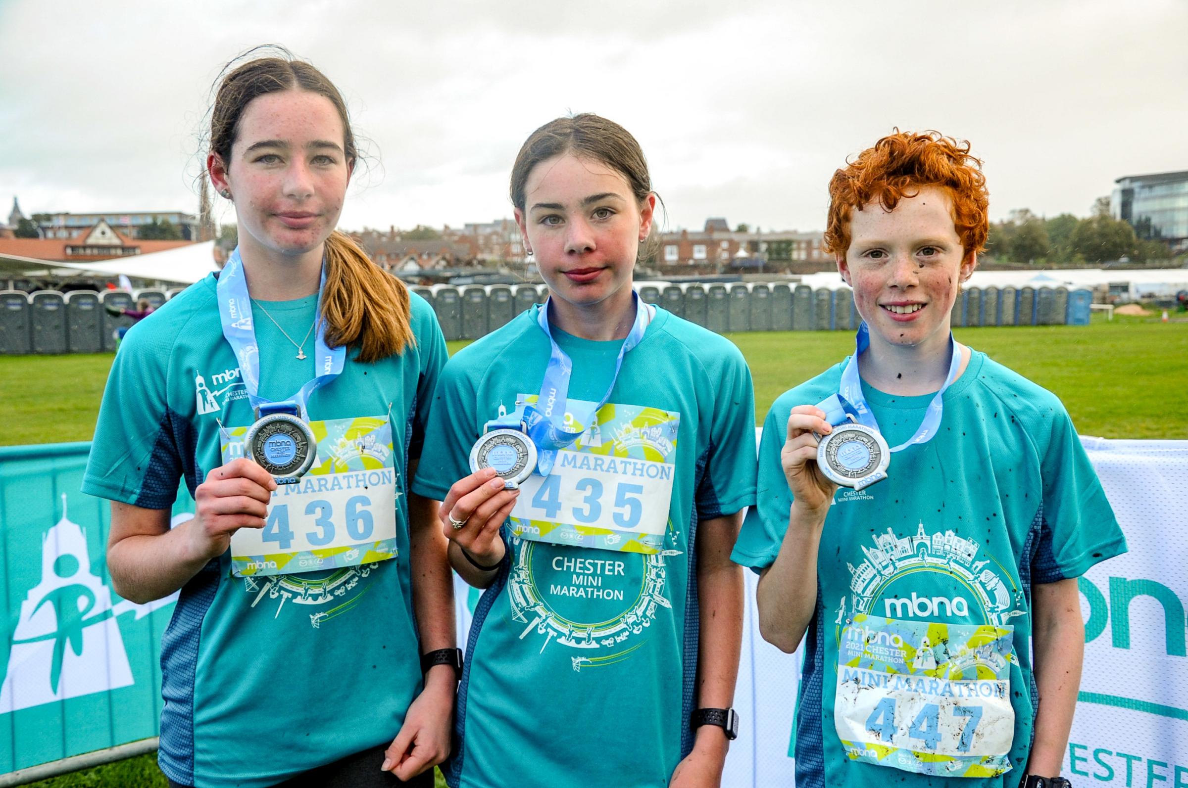 Chester Racecourse start and finish Grosvenor Park, Mbna Chester Marathon, Metric and Mini Marathon. Picture Winners of the Mini Marathon, centre first place Ruby Phillips 12, second place Amy Phillips 14 and third place Noah Woolgar 12. SW03102021.