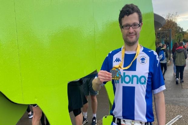 Chester FC fan Nathan Auty with his Run Chester Zoo 10k medal.