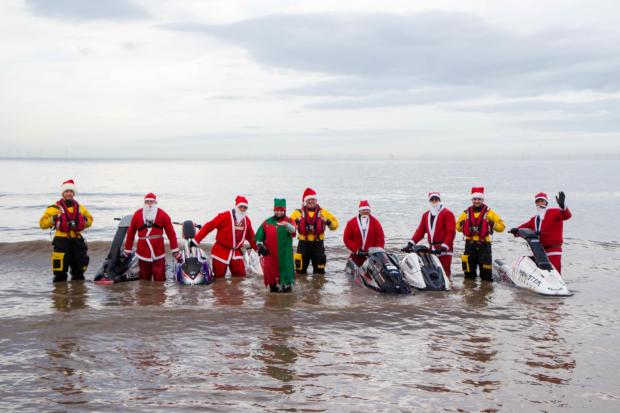 Photo shows the club members dressed in their Santa suits, together with Rhyl RNLI crew members.