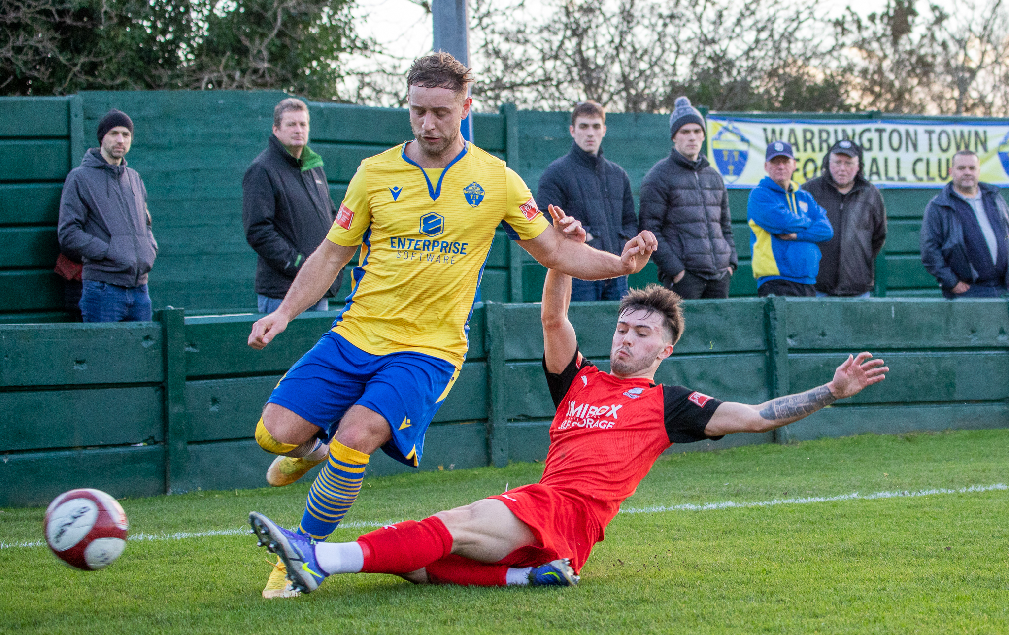 Lewis Coulton tackles Yellows full-back James Baillie while on loan at Bamber Bridge earlier this month. Picture by Jonathan Moore