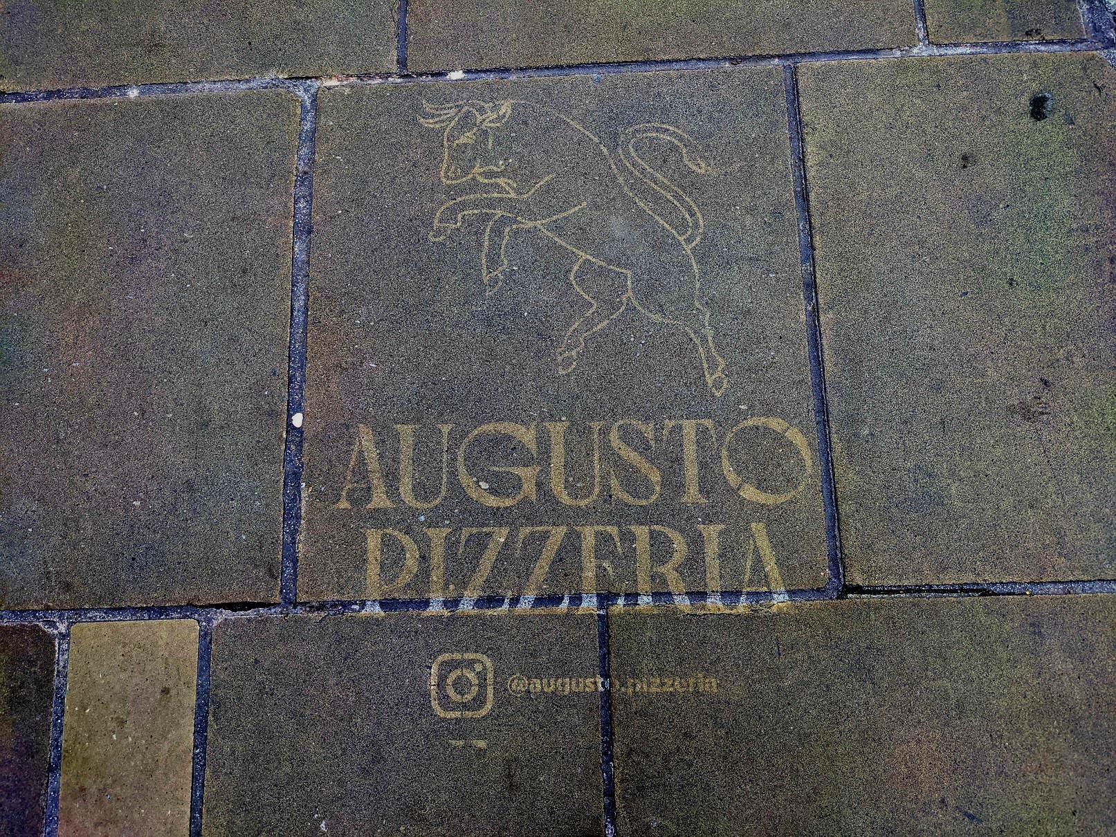 One of the clean street graffiti markings promoting the new Augusto Pizzeria restaurant in Northgate Street, Chester.