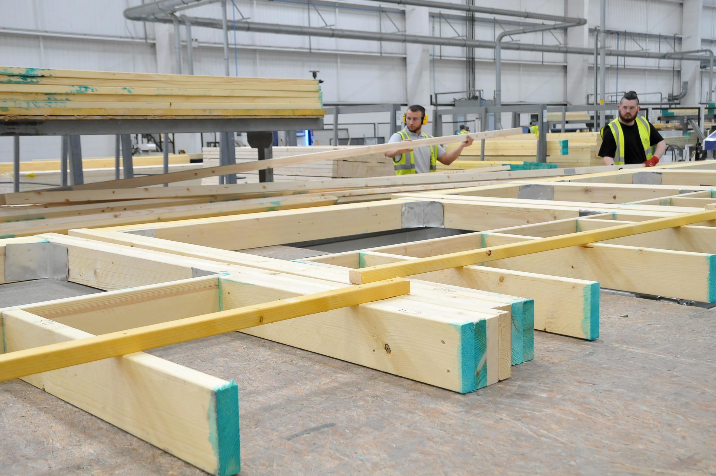 Workers prepare the timber at the beginning of the process