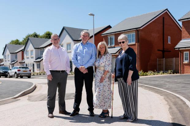 Paul Worthington (HMS managing director), Chris Bowen  (Torus Developments managing director), Lisa Newman (head of operational housing services at Wirral Council), and Pat Stewart (former headteacher of Lyndale School) outside new homes on Lyndale