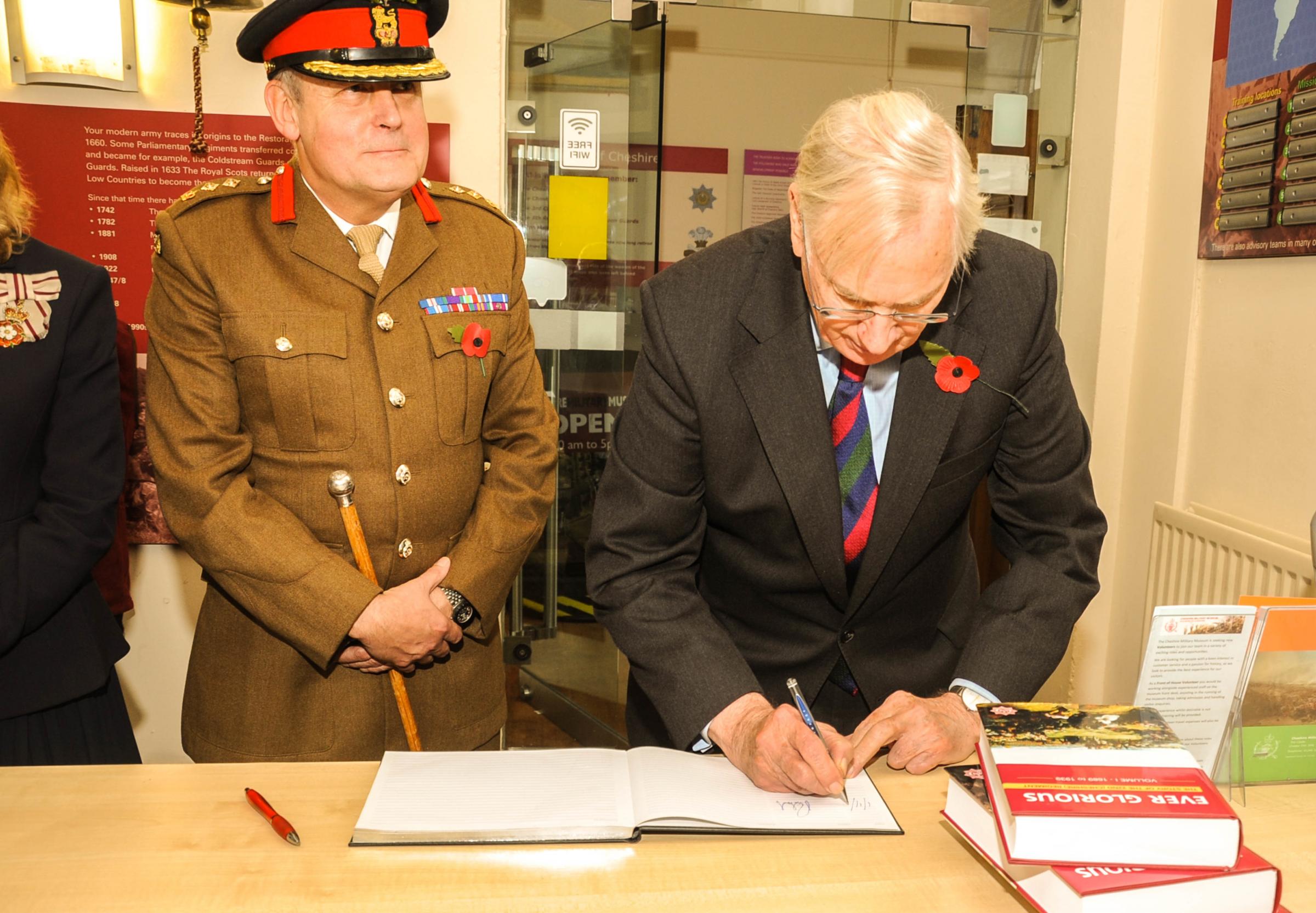 HRH The Duke of Gloucester KG signing the visitors book, looking on Colonel Martyn Forgrave OBE.