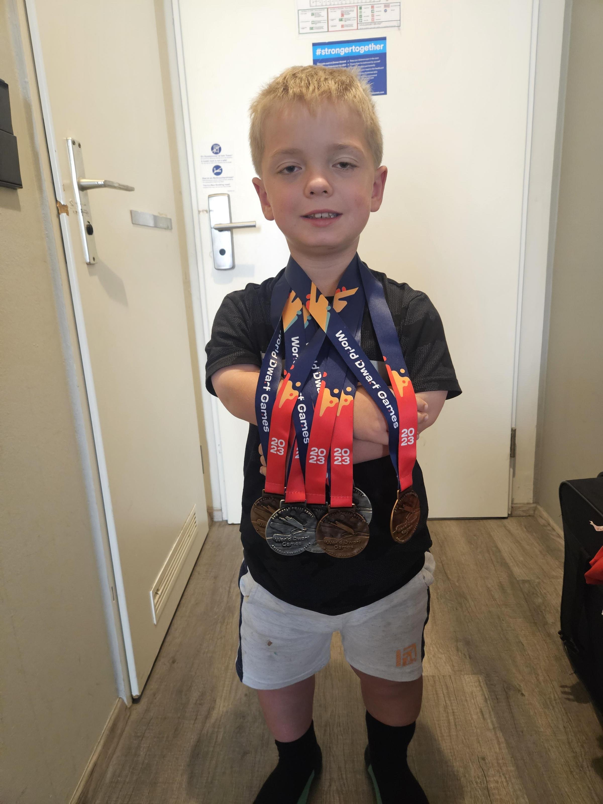 Matthew Green, nine, with his medal haul.