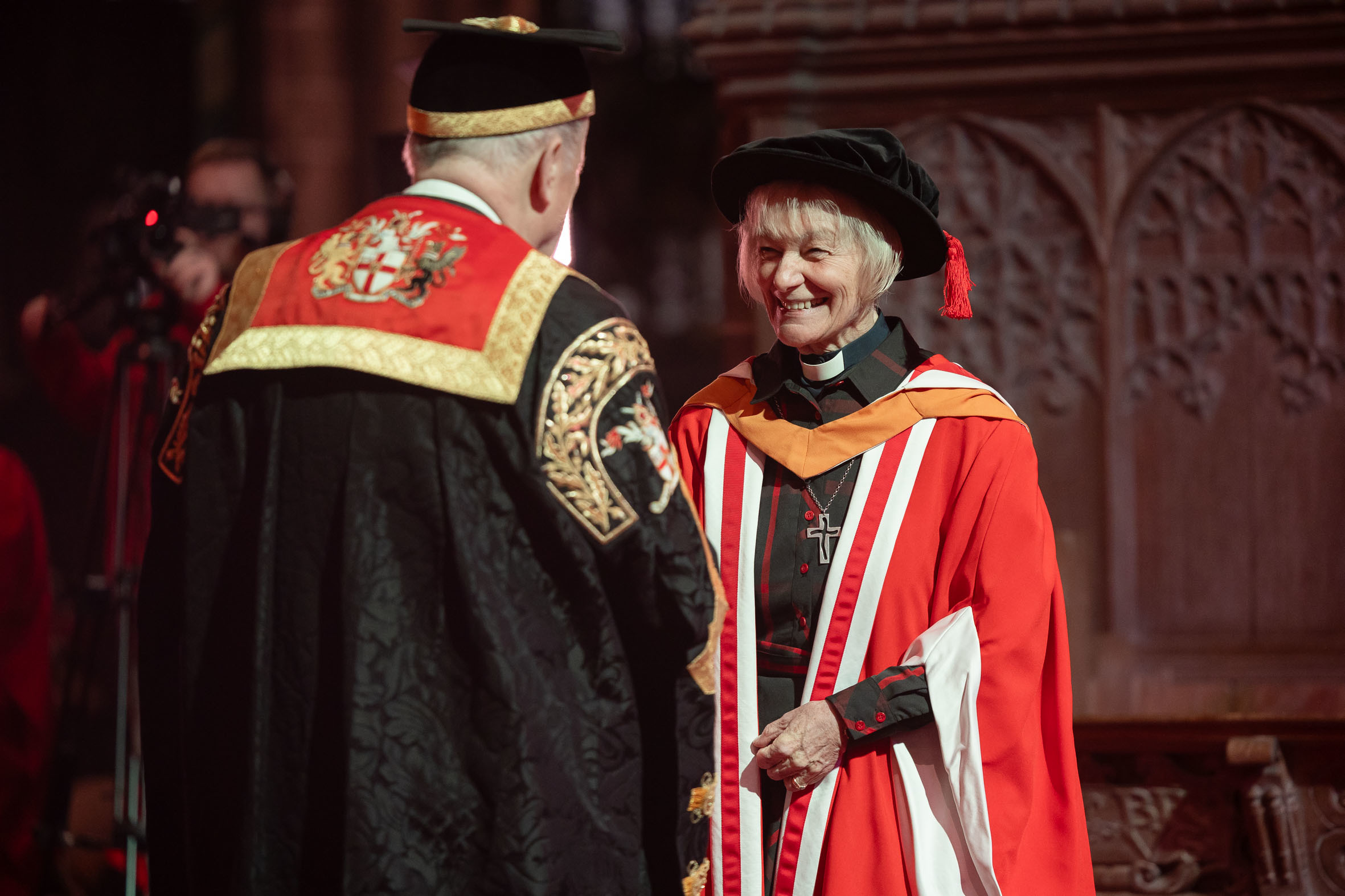 Canon Jane Brooke receiving her Honorary Doctor of Education from Dr Gyles Brandreth.
