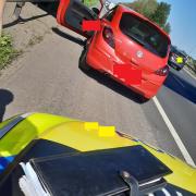 The red Corse stopped by Cheshire Police. Picture: North West Motorway Police
