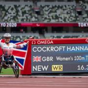 Great Britain's Hannah Cockroft poses next to the timing board showing her World Record time of 16.39 seconds which won her the Gold Medal in the Women's 100m T34 at the Olympic Stadium during day five of the Tokyo 2020 Paralympic Games in Japan.
