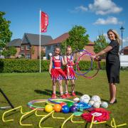 Redrow’s Meg Cardy pictured with members of Ellesmere Port Youth Netball Club at Ledsham Garden Village.