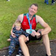 Scott Owen with his two-year-old son Arthur after finishing the Chester Marathon in support of Wales Air Ambulance charity