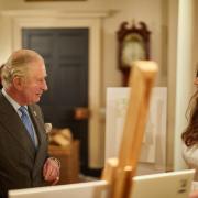 The then HRH The Prince of Wales with Emma Rose Atherton reviewing the YOOX NET-A-PORTER for The Prince's Foundation Collection