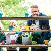 Chris Edwards, area sales manager for Redrow NW, meets pupils from Little Sutton CofE Primary School after Redrow delivered their ‘Get Set Grow’ kits.