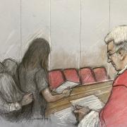 Court artist drawing by Elizabeth Cook of the parent of one of Lucy Letby's victims reading a victim impact statement at Manchester Crown Court as the serial child murderer refused to appear in court for sentencing.