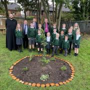 (L-R) Father Mark, Cllr Wheeler, Justin Madders MP and Bishop of Chester Mark Tanner visit the Spiritual Garden with pupils from Little Sutton C of E Primary.