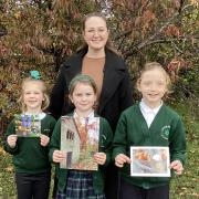 Pupils from Little Sutton CofE Primary with their photography competition entries.