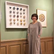 Artist Louisa Boyd with her assembled Elements artwork on display in the Escher in the Palace Museum, in the Hague.