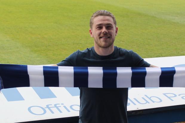 ALL SMILES: George Green pictured signing for Chester this summer before his injury problems struck